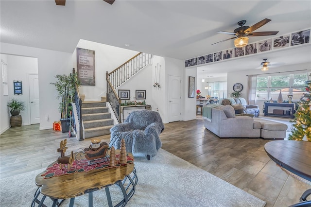 living room featuring ceiling fan and hardwood / wood-style flooring