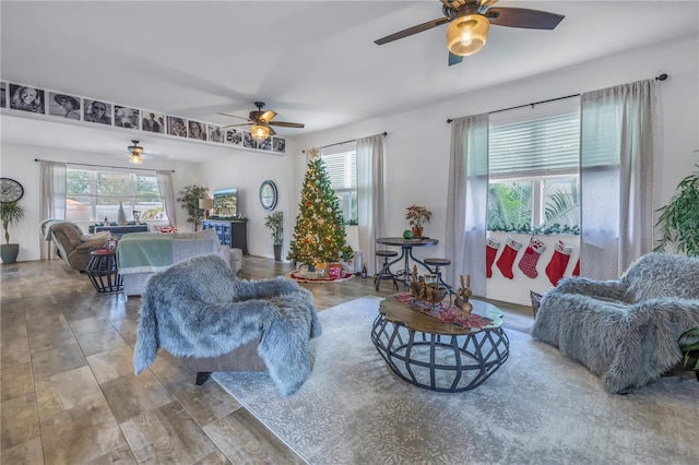 living room featuring ceiling fan and plenty of natural light