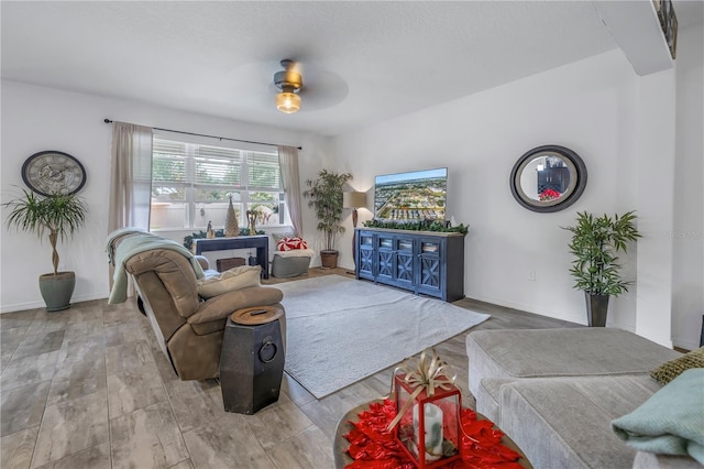 living room with hardwood / wood-style flooring and ceiling fan