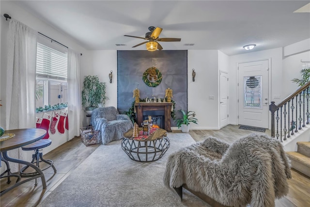 living room featuring ceiling fan and light wood-type flooring