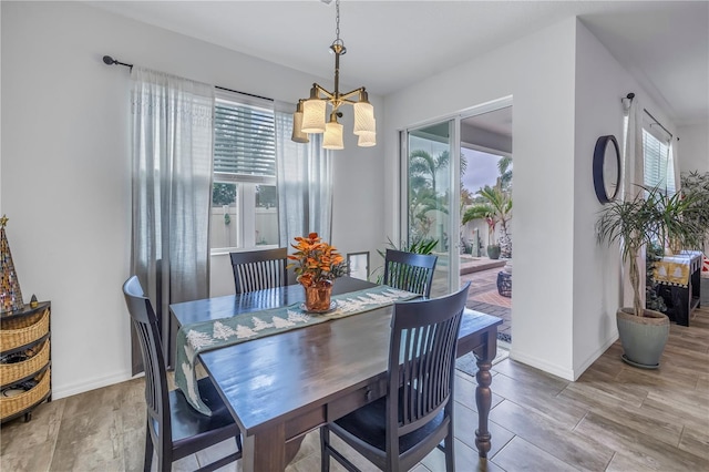 dining space with plenty of natural light and a chandelier