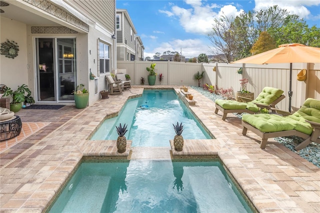 view of pool with pool water feature and a patio