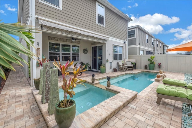 view of swimming pool featuring ceiling fan and a patio area