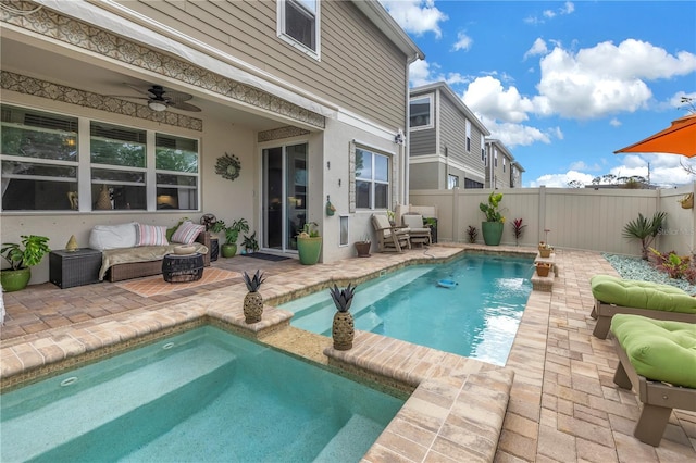 view of swimming pool with ceiling fan and a patio