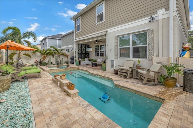 view of pool with a patio area and an in ground hot tub