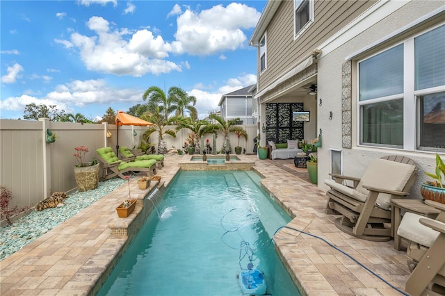 view of swimming pool with an in ground hot tub, a patio, pool water feature, and ceiling fan