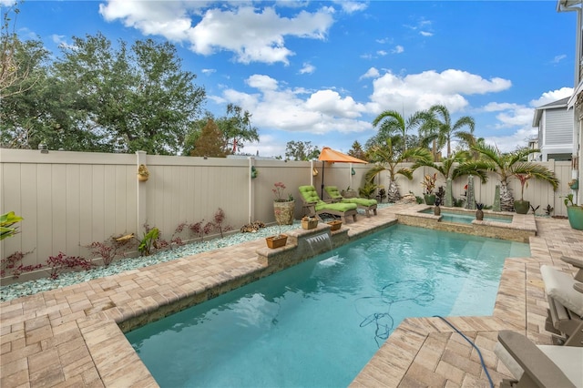 view of swimming pool featuring an in ground hot tub and pool water feature