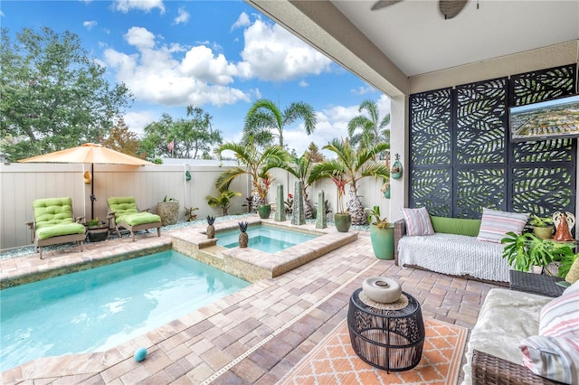 view of pool featuring an in ground hot tub, ceiling fan, and a patio area