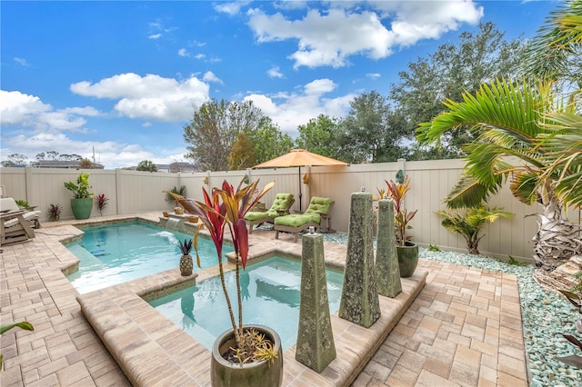 view of pool featuring a patio area and an in ground hot tub