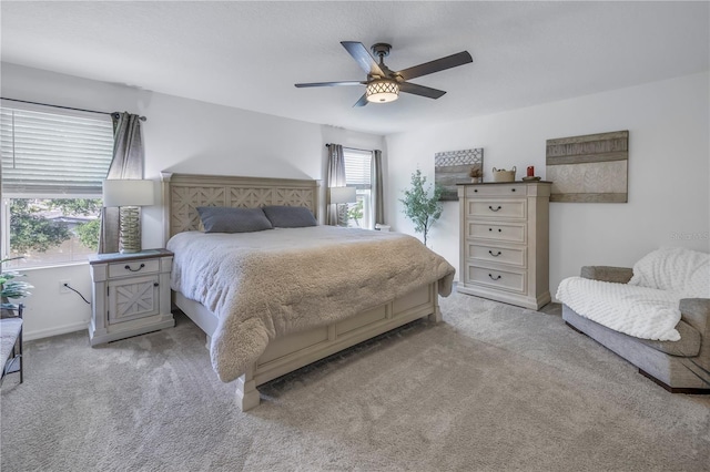 bedroom featuring ceiling fan and light carpet