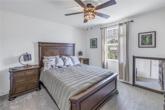 bedroom with ceiling fan and light carpet