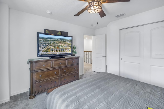 bedroom featuring light carpet, a closet, and ceiling fan