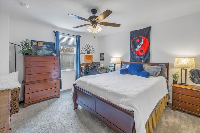 bedroom with ceiling fan and light colored carpet