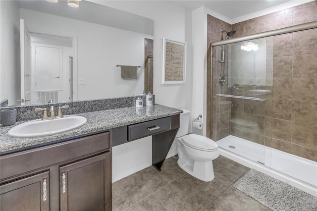 bathroom featuring tile patterned floors, vanity, toilet, and an enclosed shower