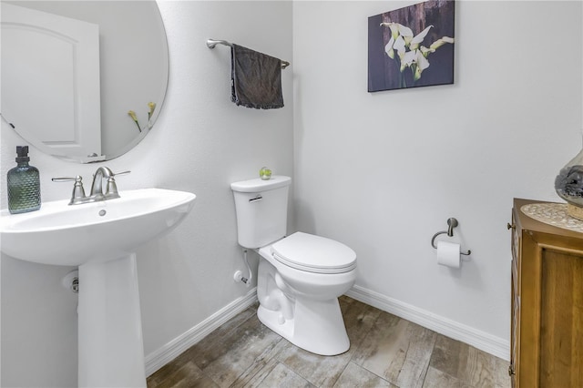 bathroom featuring hardwood / wood-style floors, toilet, and sink