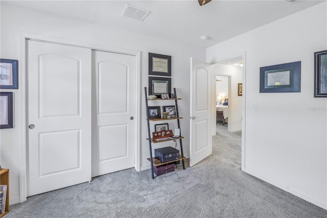 bedroom with light colored carpet and a closet