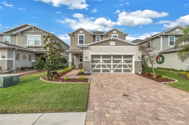 view of front of home featuring a front yard and a garage