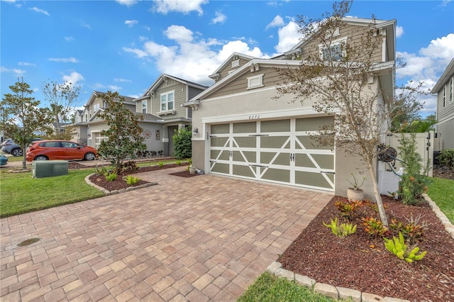 view of front of house featuring a garage and a front lawn