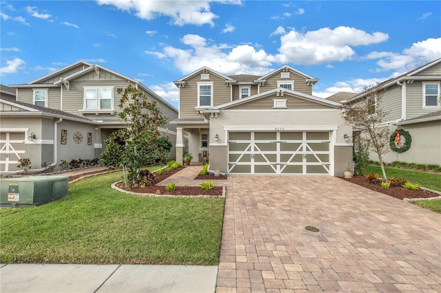 craftsman inspired home with a garage and a front yard