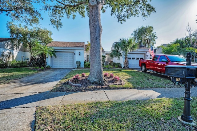 view of front of property with a garage and a front lawn