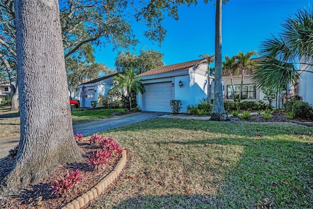 view of front of property with a garage and a front yard