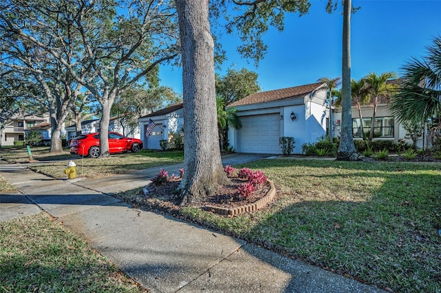 view of front of home featuring a garage and a front lawn