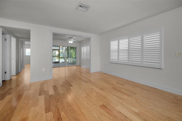 spare room with ceiling fan, a healthy amount of sunlight, and light wood-type flooring