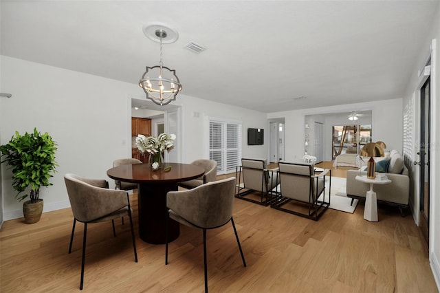 dining room with a chandelier and light hardwood / wood-style floors