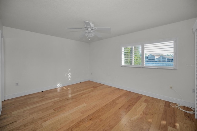 unfurnished room with ceiling fan and light wood-type flooring