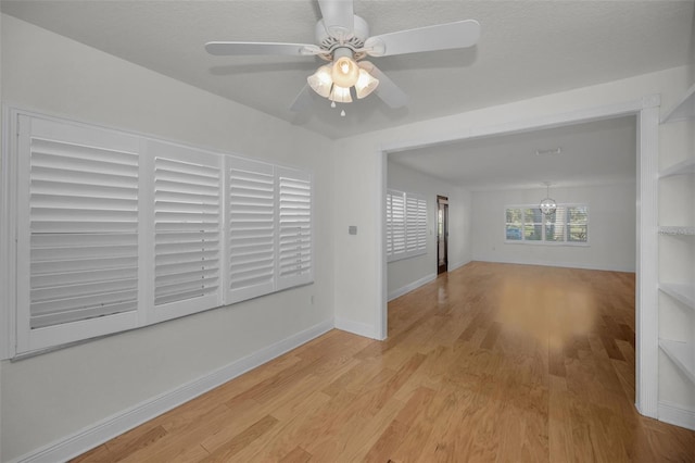 unfurnished room featuring light hardwood / wood-style flooring and ceiling fan