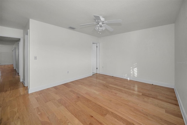 unfurnished room featuring ceiling fan, a textured ceiling, and light hardwood / wood-style floors