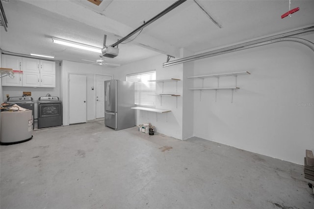 garage with a garage door opener, stainless steel fridge, and washing machine and clothes dryer