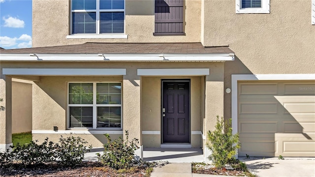 doorway to property with a garage