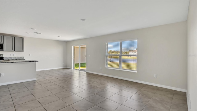 unfurnished living room featuring light tile patterned flooring