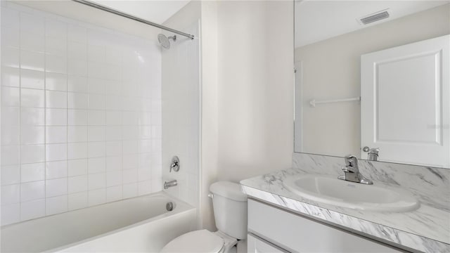 full bathroom with vanity, toilet, and tiled shower / bath combo