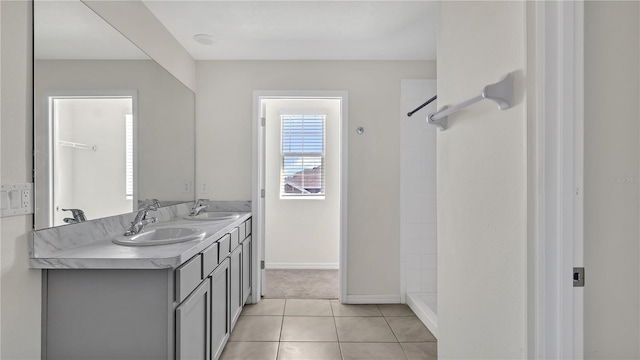 bathroom with tile patterned floors, vanity, and walk in shower