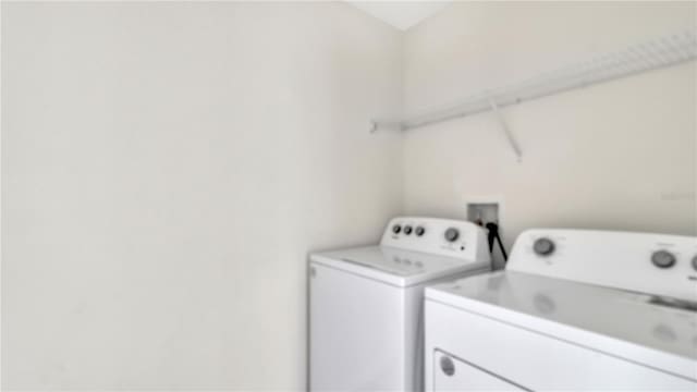 clothes washing area featuring independent washer and dryer