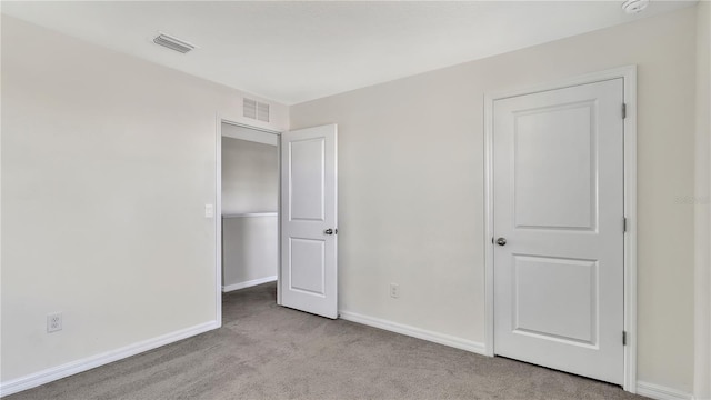 unfurnished bedroom featuring light colored carpet