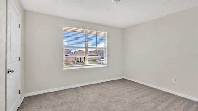 unfurnished room with light colored carpet