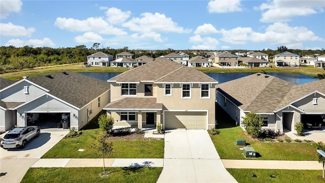 view of front of house featuring a front lawn, a water view, and a garage