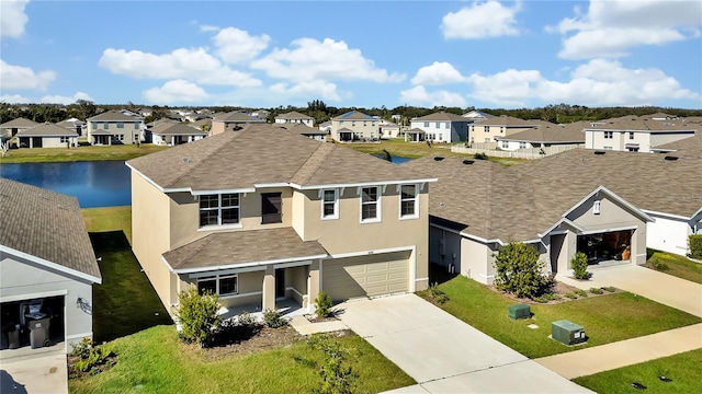 view of front facade with a garage and a water view