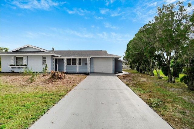 single story home with a garage and a front lawn