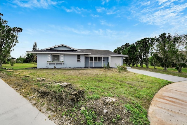 ranch-style home with a garage and a front yard