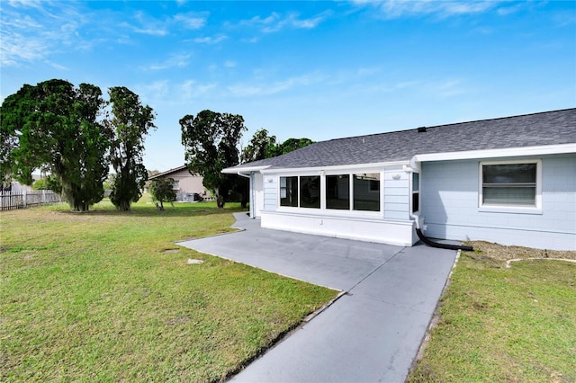 view of front of home featuring a patio and a front lawn