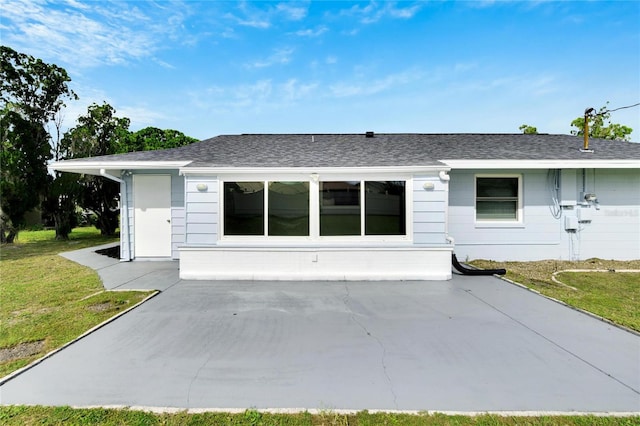 back of house with a lawn