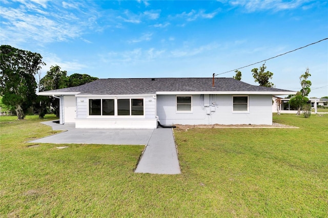 rear view of property featuring a patio area and a yard