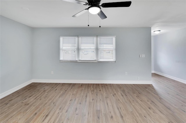 spare room with ceiling fan and light wood-type flooring