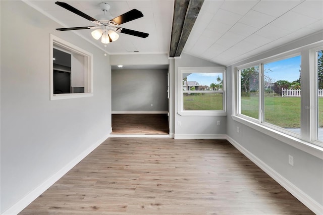 interior space with vaulted ceiling with beams and ceiling fan