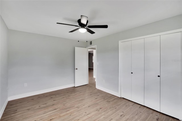 unfurnished bedroom with ceiling fan, a closet, and light hardwood / wood-style flooring