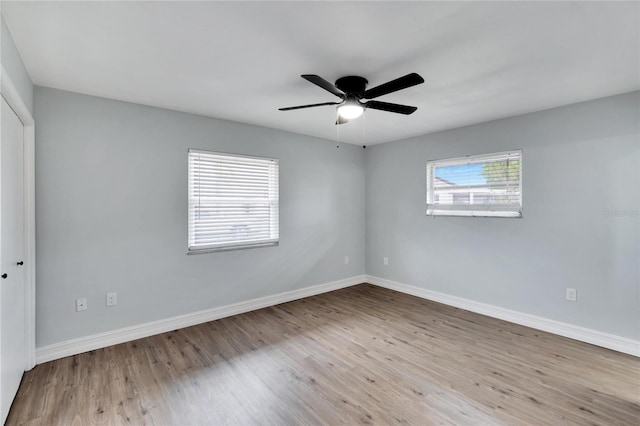 spare room with ceiling fan and light wood-type flooring